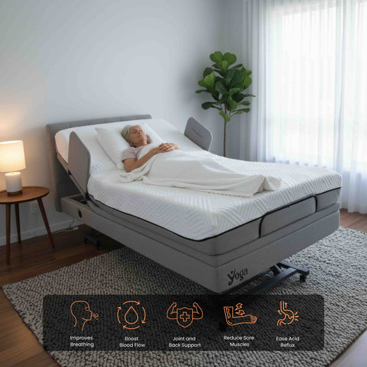 An old lady lying on a Yoga home care adjustable bed in a bedroom setting with a plant and lamp.
