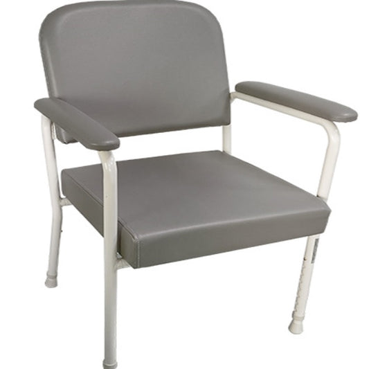 A gray low back day chair with a curved padded backrest and a wide seat, equipped with rubber stoppers on the legs from Adaptive Equipment.