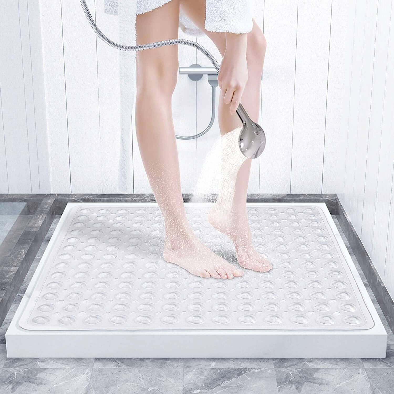 A white square anti-slip bath mat with a textured surface and suction cups | Adaptive Equipment (Image 6).