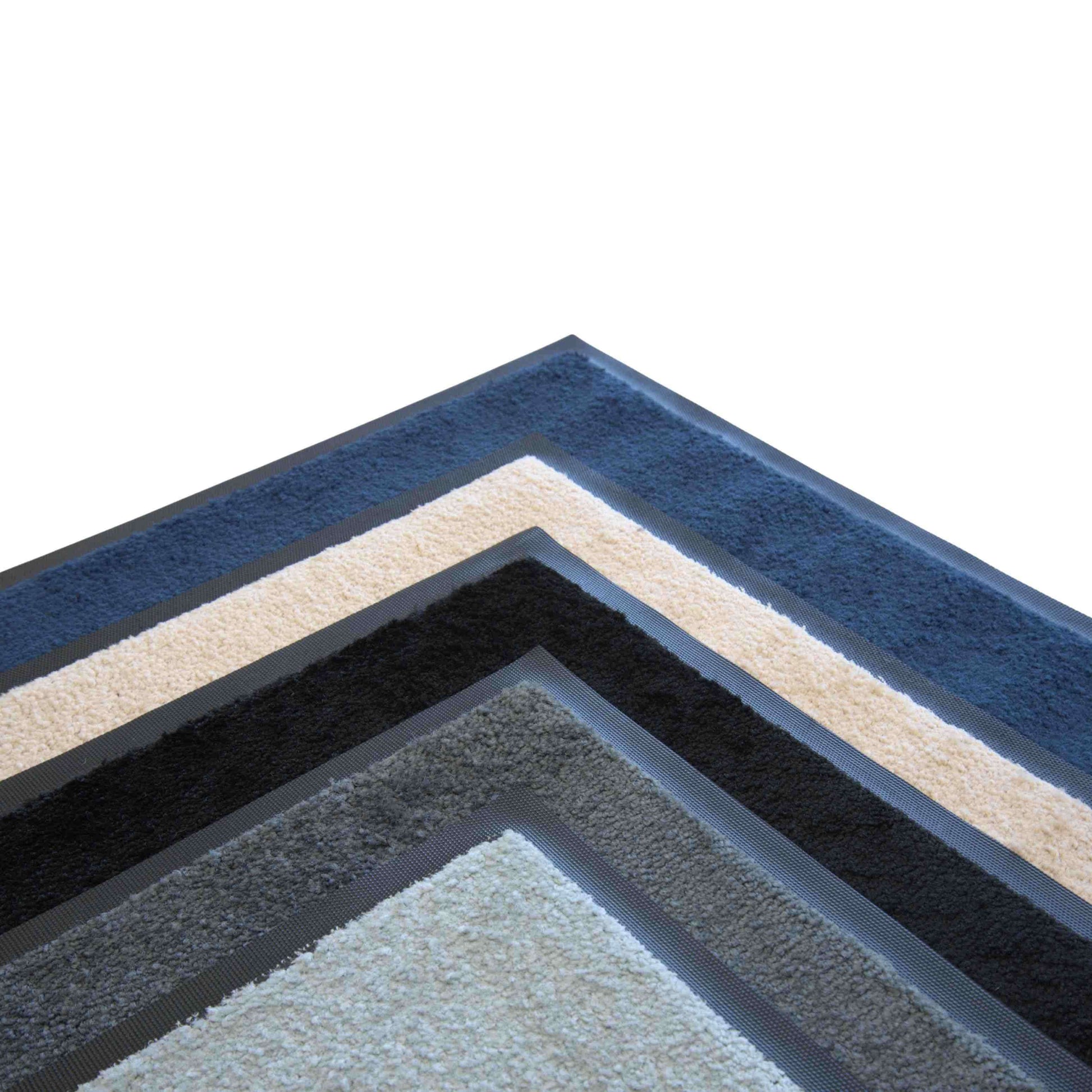 Close-up of different textured anti-slip floor mat samples in various colors on a white background
